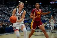 Paige Bueckers (#5) of the Connecticut Huskies is defended by JuJu Watkins (#12) of the USC Trojans during the first half of their NCAA game at the XL Center on December 21, 2024. Photo: Getty